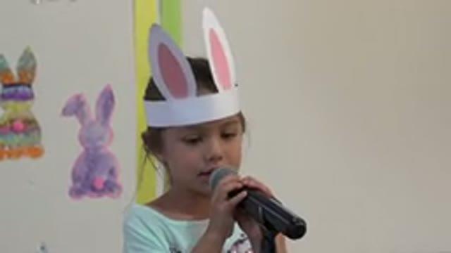 CABO SAN LUCAS MEXICO-2019: A Young Girl Wearing Paper Bunny Ears Speaks Into A