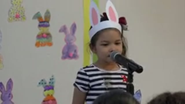 CABO SAN LUCAS MEXICO-2019: Young Girl Singing in Front of Microphone with Bunny Ears