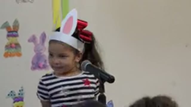 CABO SAN LUCAS MEXICO-2019: A Girl Talking On A Microphone With Paper Bunny Ears