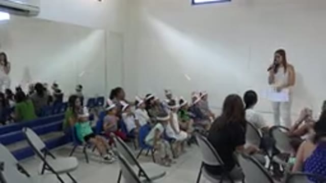 CABO SAN LUCAS MEXICO-2019: Young Children Wearing Rabbit-Ear Hats Listen To A