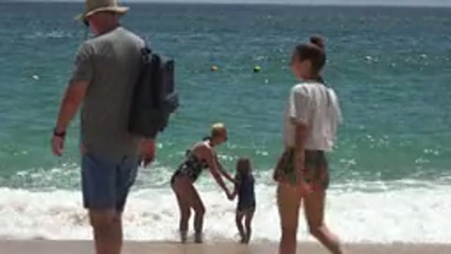 CABO SAN LUCAS MEXICO-2019: Mother And Daughter Playing And Jumping In The Waves
