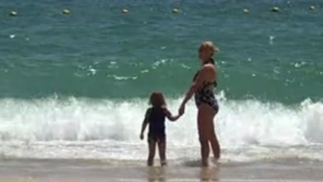 CABO SAN LUCAS MEXICO-2019: Woman Wearing Black Swimwear Stands On Beach With