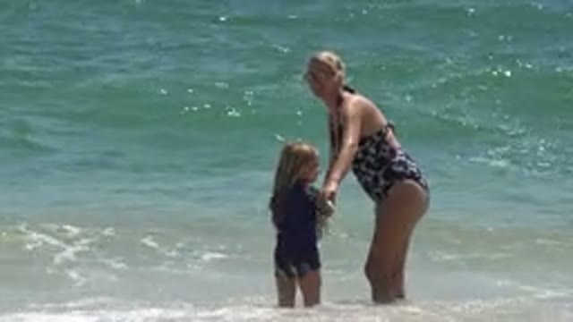 CABO SAN LUCAS MEXICO-2019: Blonde Mother and Daughter Laughing and Playing on Beach