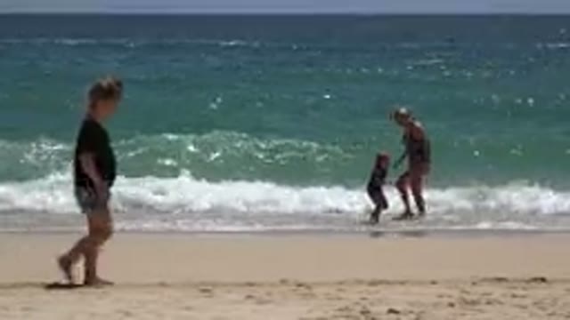 CABO SAN LUCAS MEXICO-2019: An Adult Woman Playing With A Child On The Shore