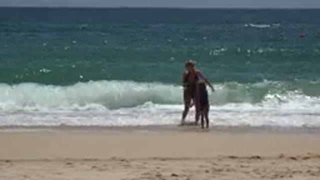 CABO SAN LUCAS MEXICO-2019: Adult Woman And Little Girl Splashing Water On Beach