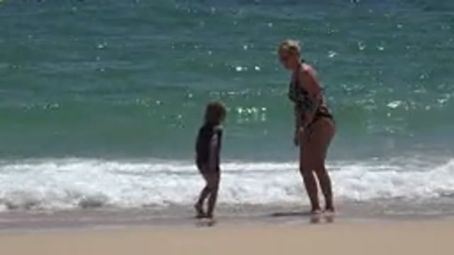 CABO SAN LUCAS MEXICO-2019: Mom And Daughter Playing On Beach Shore