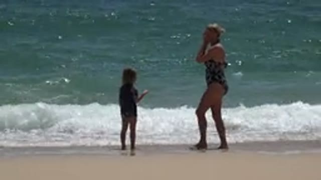 CABO SAN LUCAS MEXICO-2019: Woman Wearing Black Swimwear Stands With Girl