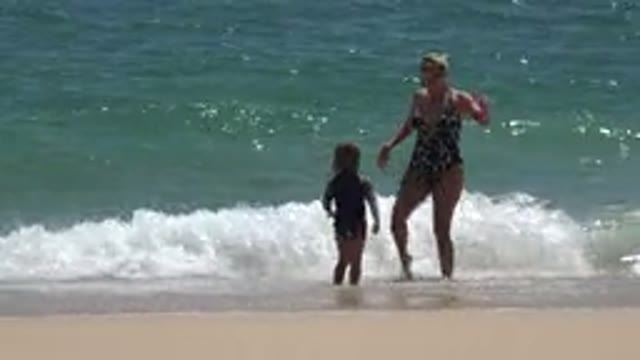 CABO SAN LUCAS MEXICO-2019: Mother And Daughter Playing In The Waves And