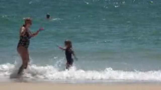 CABO SAN LUCAS MEXICO-2019: Mom And Daughter Playing At The Sea