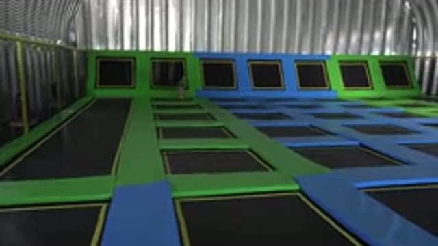CABO SAN LUCAS MEXICO-2019: Girl Wearing Pink Pants Runs Over Green and Black Mats