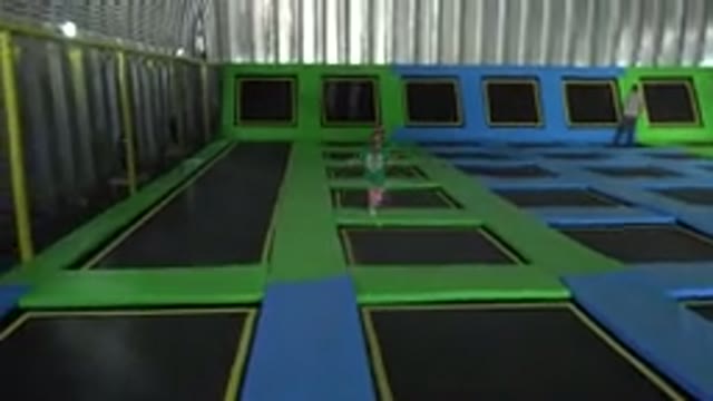 CABO SAN LUCAS MEXICO-2019: Small Girl Hops Vivaciously Across Trampolines In An