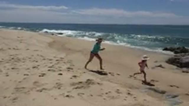CABO SAN LUCAS MEXICO-2019: Mom And Daughter Playing On The Sandy Beach