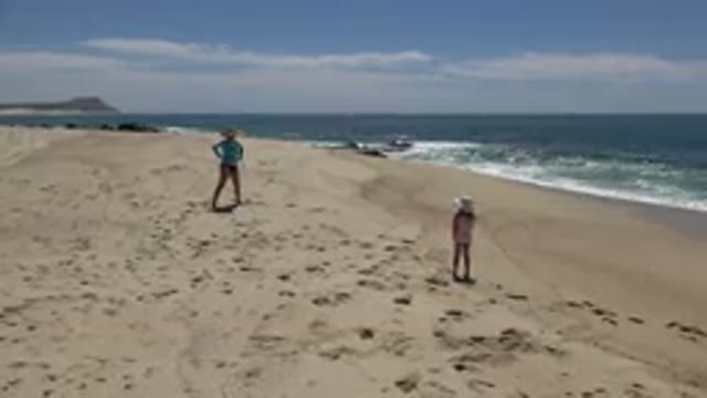 CABO SAN LUCAS MEXICO-2019: Mom And Little Girl Playing On A Sunny Beach