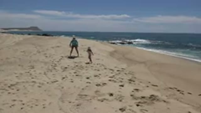 CABO SAN LUCAS MEXICO-2019: Mother And Daughter Have Fun Playing Chase On The