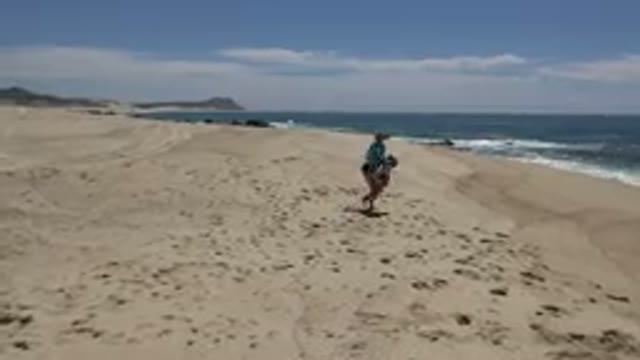 CABO SAN LUCAS MEXICO-2019: Mom And Daughter Playing In The Sand At Beach
