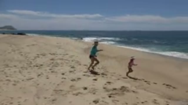 CABO SAN LUCAS MEXICO-2019: Mom And Daughter Running Along The Beach On A Sunny Day