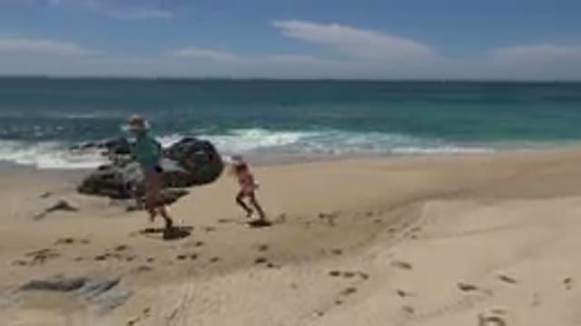 CABO SAN LUCAS MEXICO-2019: Little Girl And Mother Running On The Sunny Beach At