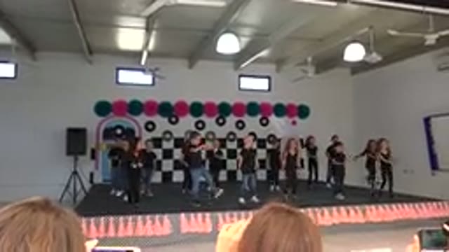 CABO SAN LUCAS MEXICO-2019: Kids Wearing Black Shirts Dance on Black and Orange Stage