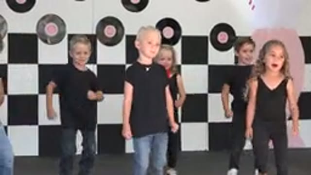 CABO SAN LUCAS MEXICO-2019: Kids Wearing Black Shirts Perform Dance On Pink Decorated Stage
