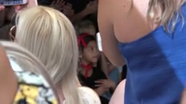 CABO SAN LUCAS MEXICO-2019: A Little Girl In Black Dress Standing In Front Of Audience