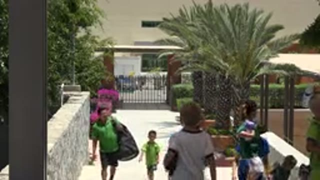CABO SAN LUCAS MEXICO-2019: Children Standing In Front Of A Building Getting