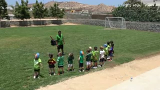 CABO SAN LUCAS MEXICO-2019: Smart Little Kids Play Soccer On A Grass Field