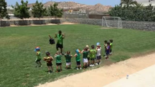 CABO SAN LUCAS MEXICO-2019: Coach Showing Kids How To Heat Up Before Play
