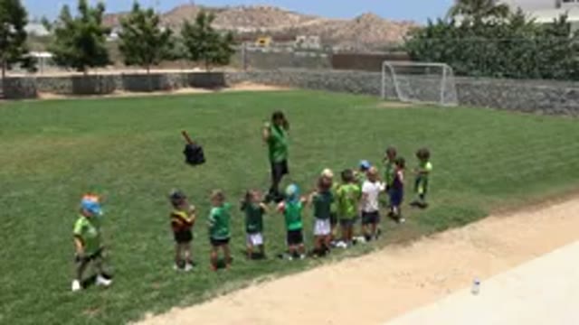 CABO SAN LUCAS MEXICO-2019: A Man And Several Kids Standing Together In A Soccer Field