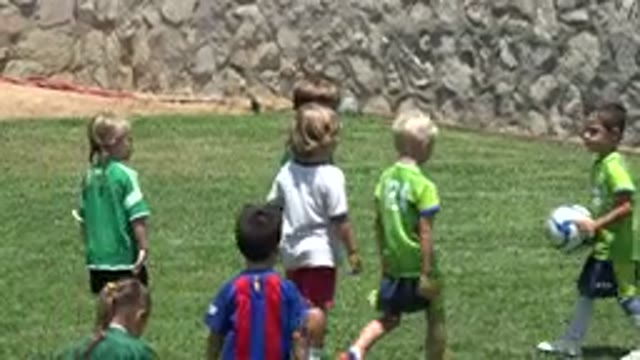 CABO SAN LUCAS MEXICO-2019: Energetic Little Kids Play Soccer On Grass