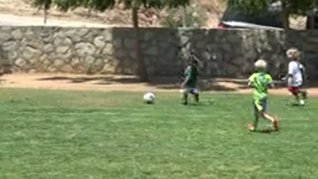 CABO SAN LUCAS MEXICO-2019: Little Girl With A Ponytail Wearing A Green Shirt Playing Soccer