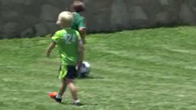 CABO SAN LUCAS MEXICO-2019: Several Children In Green Uniforms Playing Football