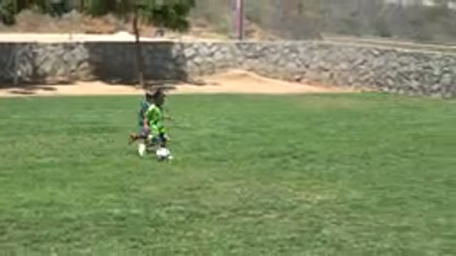 CABO SAN LUCAS MEXICO-2019: Two Teams of Kids Playing Soccer in the Light