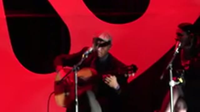 CABO SAN LUCAS MEXICO-2019: Couple Sitting On Stage Man In Hat Playing Guitar