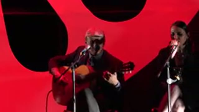CABO SAN LUCAS MEXICO-2019: Man Wearing Grey Pants Plays Guitar Sitting Near Woman
