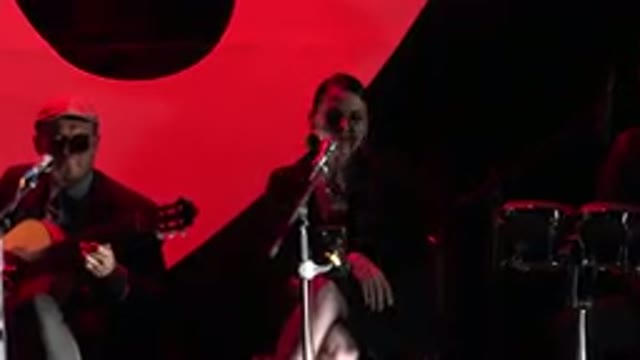 CABO SAN LUCAS MEXICO-2019: A Woman Wearing Black Singing Into The Microphone