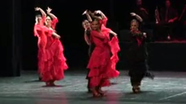 CABO SAN LUCAS MEXICO-2019: Several Women In Red And Black Dresses Performing A Synchronized Dance