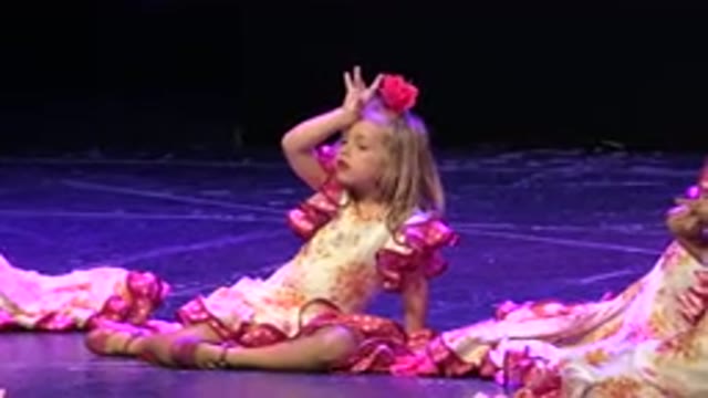 CABO SAN LUCAS MEXICO-2019: A Small Girl On Stage In A Pink Outfit With Her Hand