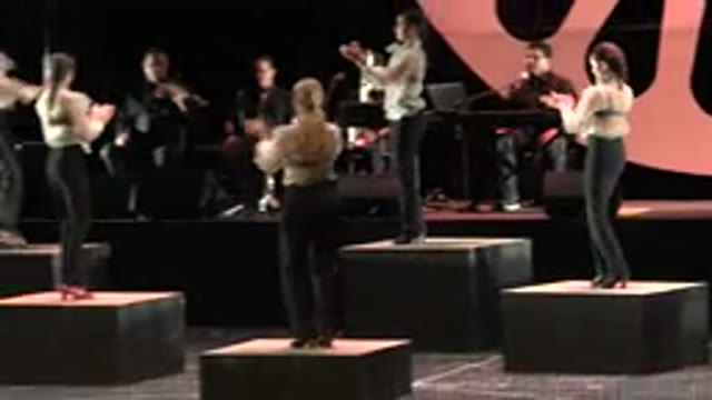 CABO SAN LUCAS MEXICO-2019: People In Matching Costumes Stand On Boxes While Clapping And Stomping