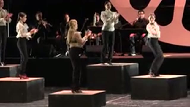 CABO SAN LUCAS MEXICO-2019: Group Of Women Wearing Black Trousers And White Blouses Dancing