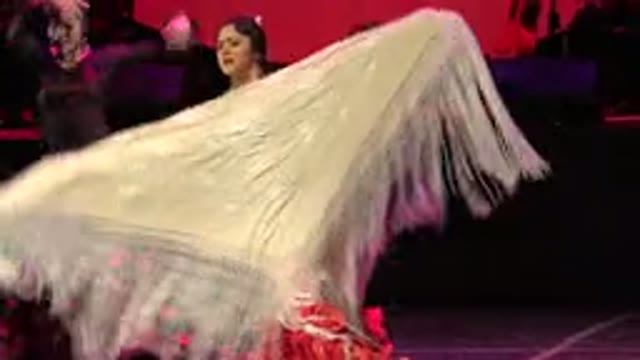 CABO SAN LUCAS MEXICO-2019: Three Women Wearing Long Red Dresses With Ruffles Dancing Near a Tree