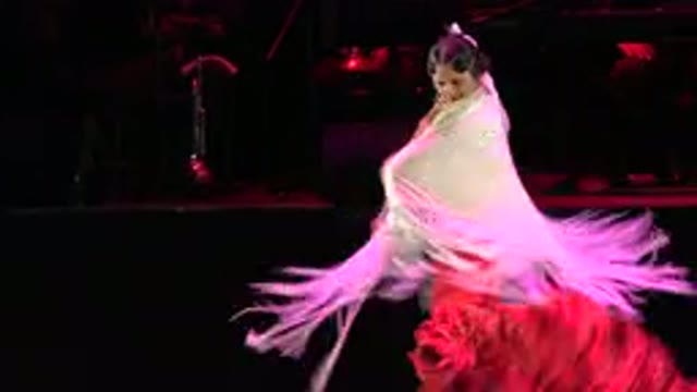 CABO SAN LUCAS MEXICO-2019: Woman In Red Gown And Gold Scarf Dances Cheerfully