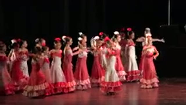 CABO SAN LUCAS MEXICO-2019: A Group Of Little Girls In Red Dresses Performing On Stage