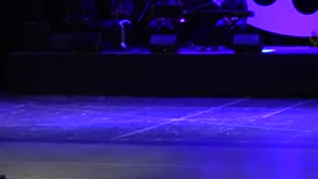 CABO SAN LUCAS MEXICO-2019: Dancers On Stage With Big Wheel In Background Camera Panning Left