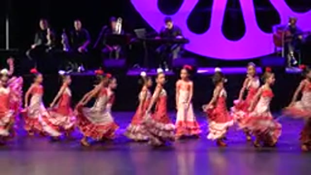 CABO SAN LUCAS MEXICO-2019: A Large Group Of Girls Dancing Salsa On Stage In Frilly Outfits