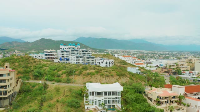 SAN JOSE DEL CABO BCS MEXICO-2021: Panning View of Hillside Buildings and Mountain Range