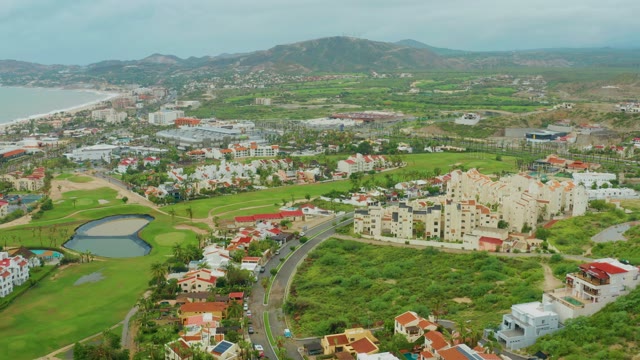SAN JOSE DEL CABO BCS MEXICO-2021: Vehicles Moving Along a Coastal Road near a Golf Course