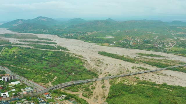 SAN JOSE DEL CABO BCS MEXICO-2021: Muddy River Flowing Through Valley With Bridge