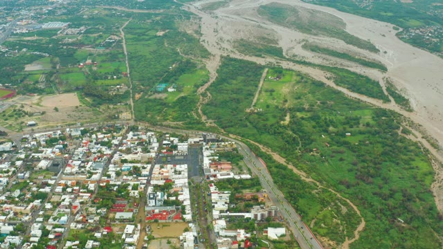 SAN JOSE DEL CABO BCS MEXICO-2021: Muddy River Receding Near Urban Area
