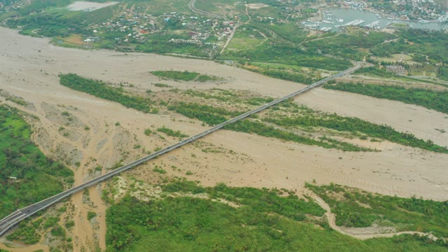 SAN JOSE DEL CABO BCS MEXICO-2021: Muddy River Flowing Under a Long Bridge