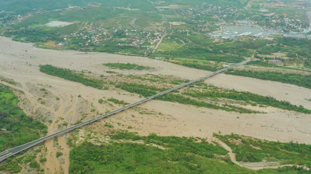 SAN JOSE DEL CABO BCS MEXICO-2021: Muddy River Flowing Under a Long Bridge